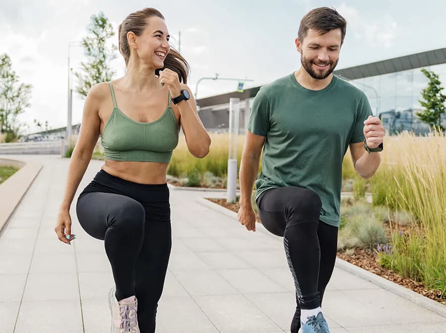 Two residents jogging along a landscaped path, from The Thornhill Gardens marketing